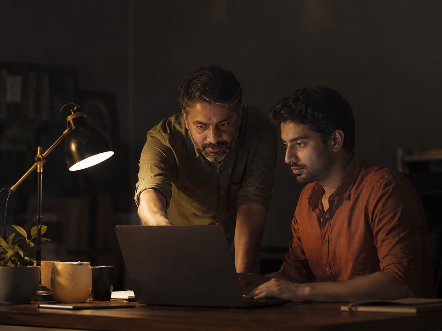 Two colleagues working together at a laptop